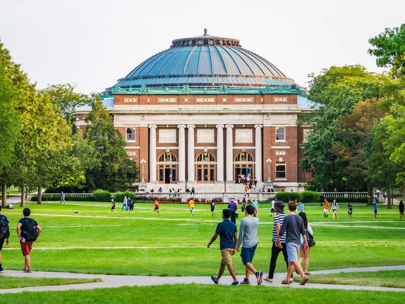 Students walk on university campus quad