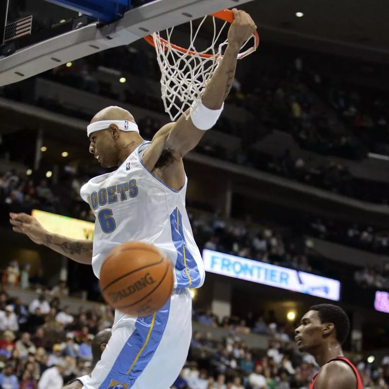 Kenyon Martin hangs on rim after dunking