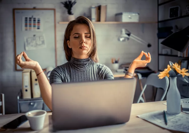 Woman in office meditating