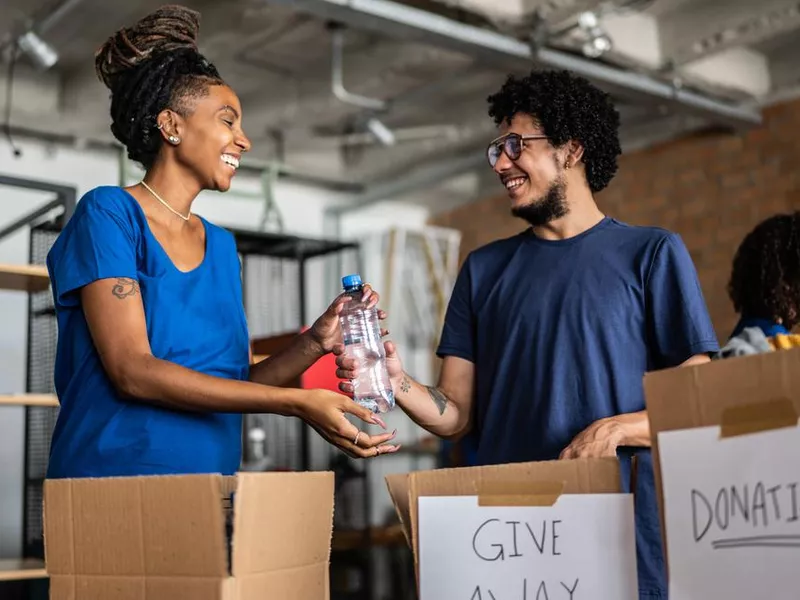 Volunteers arranging donations in a community charity donation center