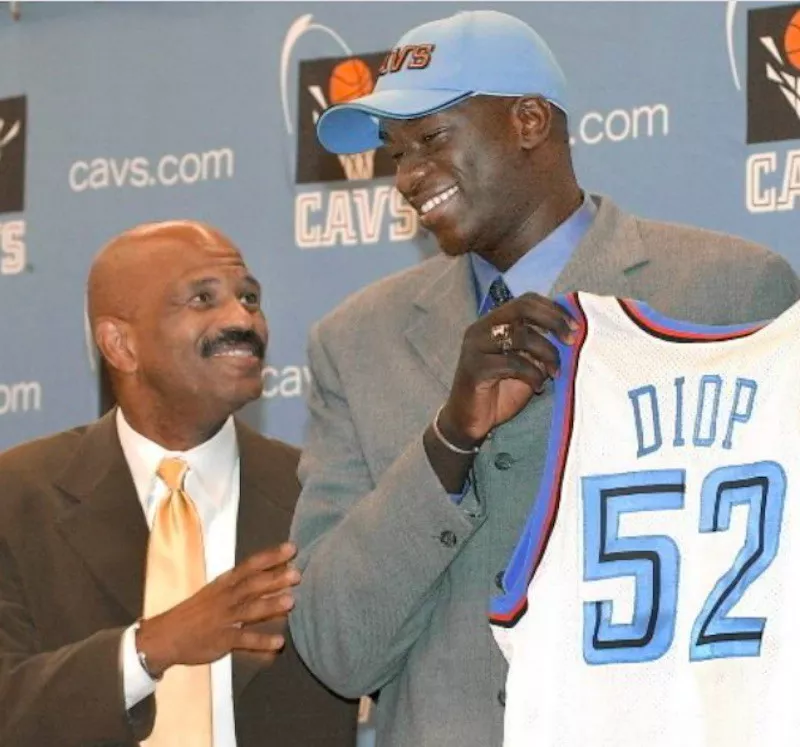 DeSagna Diop holding up jersey