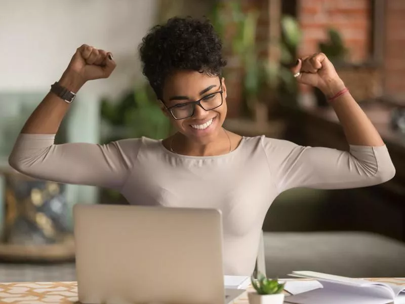 Excited woman with laptop