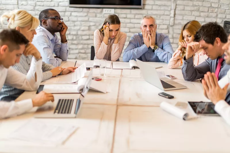 Large group of worried business people having a meeting