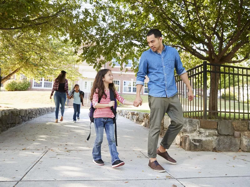 Father Picking Up Daughter At The End Of School