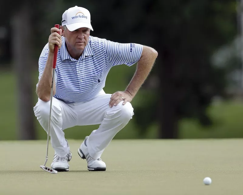 Davis Love III lines up putt