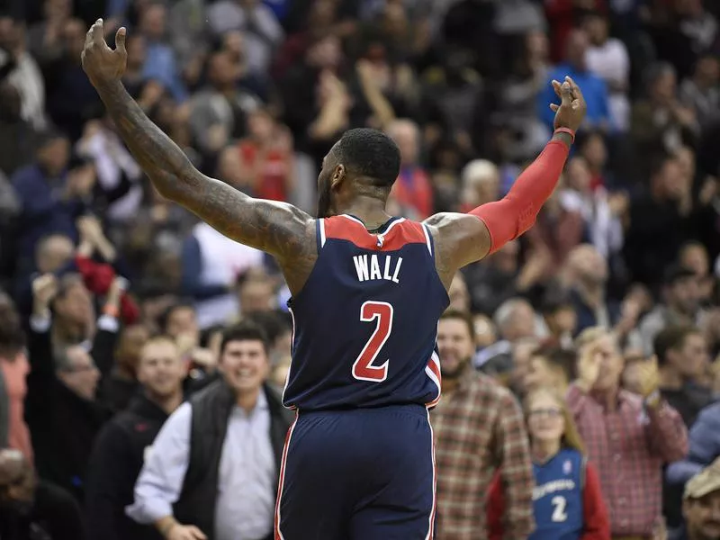 Washington Wizards guard John Wall gestures to crowd