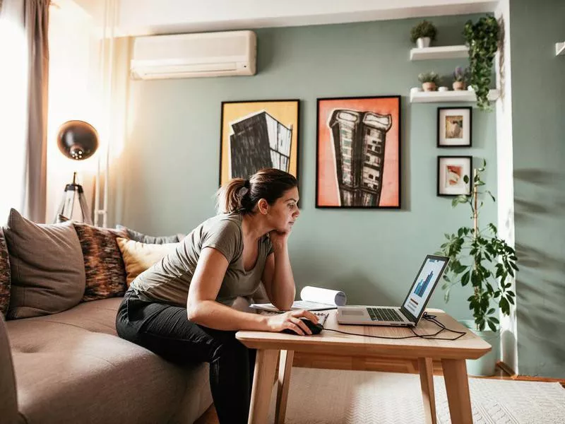 Woman working from her couch