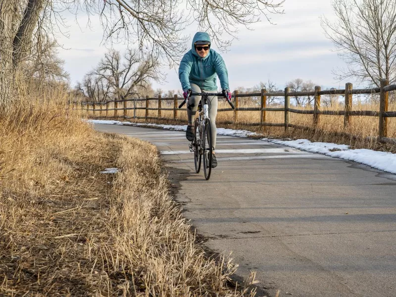 Male cyclist is biking on the Poudre River Corridor trail