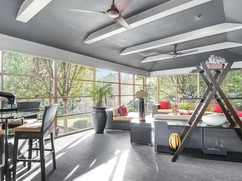 Large sun room with floor to ceiling windows