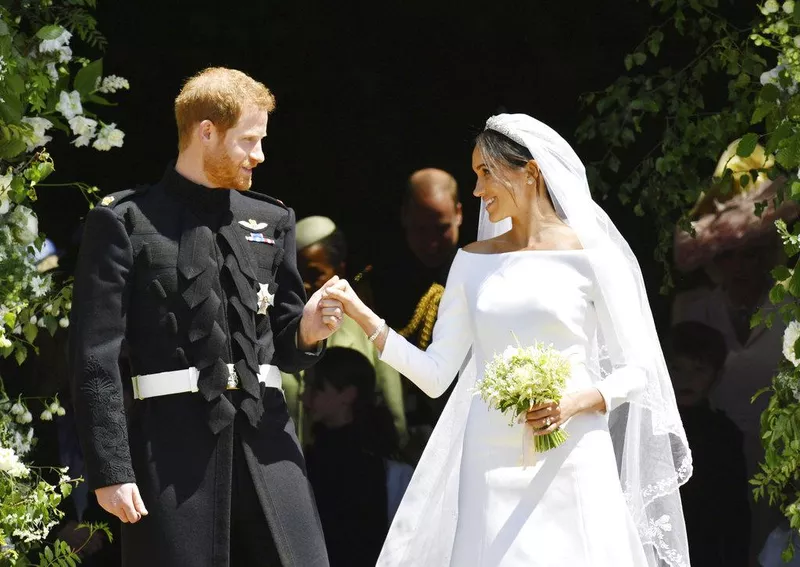 Britain's Prince Harry and Meghan Markle stand on the steps of St. George's Chapel