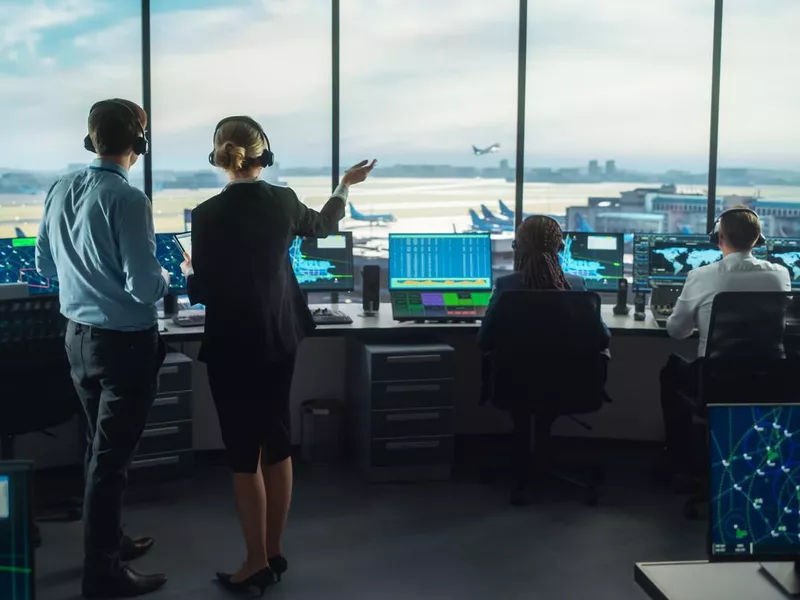 Air traffic controllers with headsets