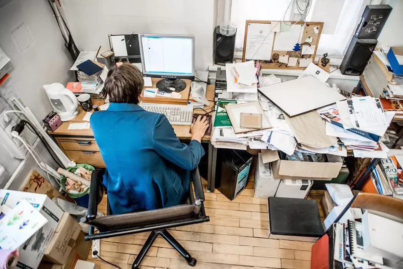 Woman working at messy desk