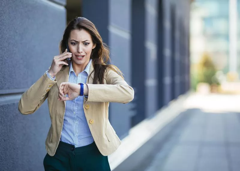 Woman checks time on watch